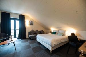 una camera d'albergo con un letto e un divano di Smart Bnb - Hotel Battice a Battice