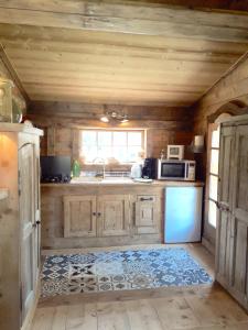 a kitchen with a refrigerator and a stove top oven at Charmant Mazot in Saint-Gervais-les-Bains