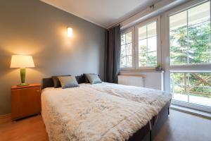 Posteľ alebo postele v izbe v ubytovaní Flatbook Apartamenty - Krynica Morska Żeromskiego