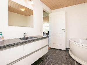 a bathroom with a sink and a bath tub at 8 person holiday home in Skals in Sundstrup