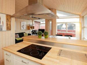 a kitchen with a stove top oven in a room at 6 person holiday home in Tranek r in Fæbæk
