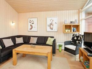 a living room with a couch and a coffee table at 6 person holiday home in Tranek r in Fæbæk