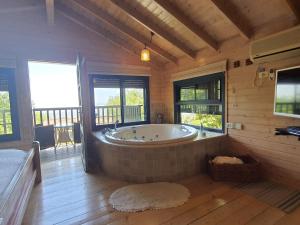 a large bathroom with a large tub in a cabin at Eretz Hagalil - Land of Galilee in Amirim +37 photos