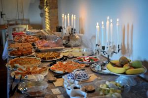 a buffet of food on a table with candles at Agriturismo Il Segreto di Pietrafitta in San Gimignano