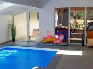 a swimming pool in a living room with a house at 10 person holiday home in Thisted in Klitmøller