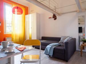 a living room with a couch and a table at The Best Rent - Studio Apartment close to Cinque Giornate in Milan