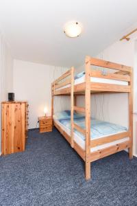 a bedroom with two bunk beds in a room at Ferienwohnungen im Haus Trudi in Bensersiel