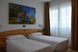 Posteľ alebo postele v izbe v ubytovaní Hotel Portavaldera