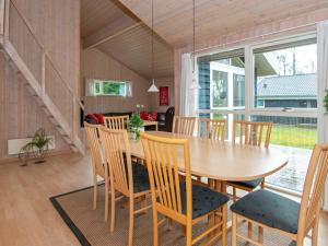 a dining room with a wooden table and chairs at 8 person holiday home in Sydals in Sarup
