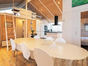 a kitchen and dining room with a table and chairs at 14 person holiday home in Løkken-By Traum in Grønhøj