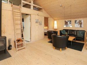 a living room with a loft bed and a fireplace at 6 person holiday home in Ringk bing in Søndervig