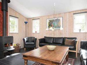 a living room with a couch and a table at 10 person holiday home in Ebeltoft in Ebeltoft