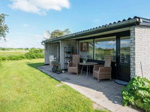 a house with a patio with a table and chairs at Holiday home Broager IV in Broager