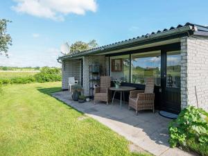 a house with a patio with a table and chairs at 4 person holiday home in Broager-By Traum in Broager