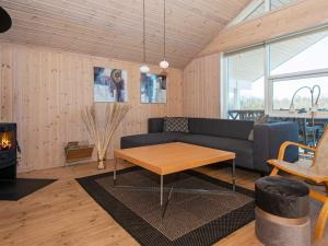 a living room with a couch and a table at 6 person holiday home in Ringk bing in Nørby
