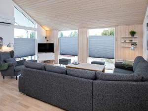 a living room with a couch and a table at 6 person holiday home in V ggerl se in Bøtø By