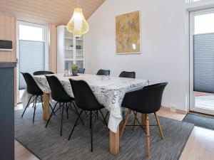 a dining room with a table and chairs at 6 person holiday home in V ggerl se in Marielyst