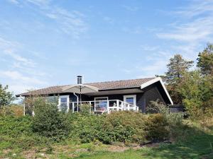 a house sitting on top of a hill at Two-Bedroom Holiday home in Kalundborg 1 in Bjørnstrup
