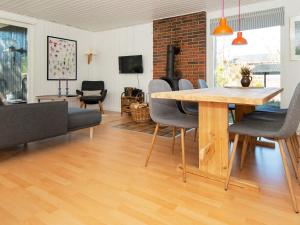 a living room with a wooden table and chairs at 5 person holiday home in Glesborg in Glesborg