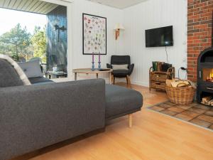a living room with a couch and a fireplace at 5 person holiday home in Glesborg in Glesborg