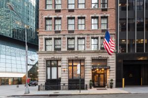 a building with an american flag in front of it at Eurostars Wall Street in New York