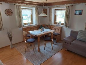 a living room with a table and chairs and a couch at Haus Tauernblick in Berchtesgaden