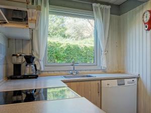 a kitchen with a sink and a window at 8 person holiday home in Allinge in Allinge