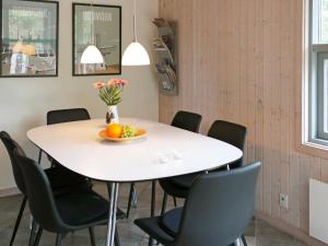 een witte tafel met stoelen en een fruitschaal erop bij 6 person holiday home in Fjerritslev in Torup Strand