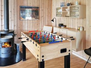 a chess board in a room with a fireplace at 12 person holiday home in V ggerl se in Marielyst