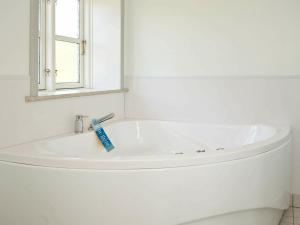 een witte badkamer met een wastafel en een spiegel bij 6 person holiday home in Hejls in Hejls