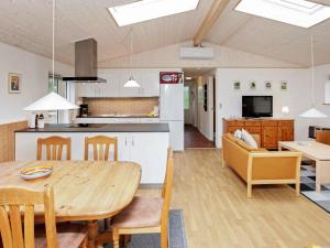 a kitchen and dining room with a table and chairs at 6 person holiday home in Jerup in Jerup