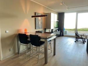 a kitchen with a table and chairs in a room at Hello Zeeland - Appartement Port Scaldis 01-001 in Breskens
