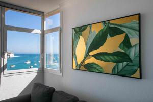 a living room with a large window and a painting at La Buena Vida, by Comfortable Luxury in Corralejo