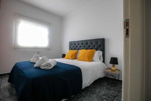 a bedroom with a large bed with yellow pillows at La Buena Vida, by Comfortable Luxury in Corralejo