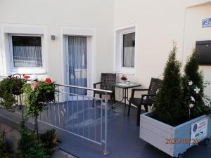 a balcony with chairs and a table and plants at Haus Schmidt in Berchtesgaden