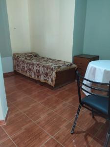 a bedroom with a bed and a chair and a table at Los Patos in Chumillo