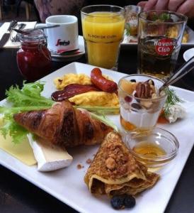 a plate of breakfast food on a table at Chez Eva Jolie in Dakar