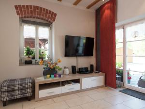 a living room with a flat screen tv on a wall at Comfortable holiday home in Saxony with terrace in Oederan