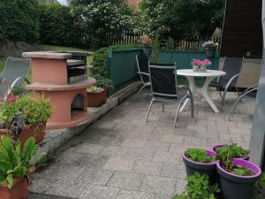 un patio con mesa, sillas y plantas en Holiday Home in H ttenrode with private terrace, en Hüttenrode