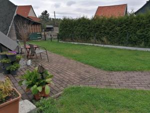 a brick patio with a table and a bench in a yard at Holiday Home in H ttenrode with private terrace in Hüttenrode