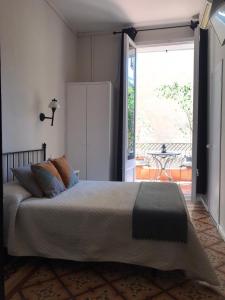 a bedroom with a bed and a large window at Casa Consell Gran Via, Guest House in Barcelona