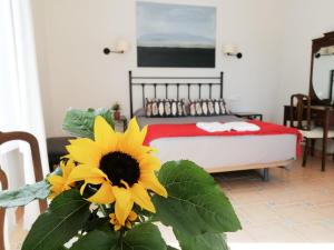 a bedroom with a bed with a yellow sunflower at Casa Consell Gran Via, Guest House in Barcelona