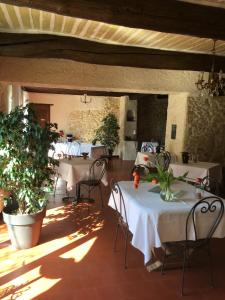 a room with tables and chairs in a building at La Mandarine in Piolenc