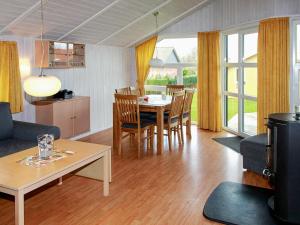 ein Wohnzimmer mit einem Tisch und einem Esszimmer in der Unterkunft Two-Bedroom Holiday home in Gelting 1 in Gelting