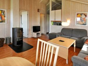 a living room with a couch and a table at Two-Bedroom Holiday home in Gelting 1 in Gelting