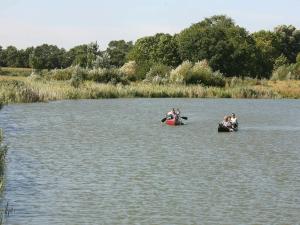 two people in canoes in the water at 12 person holiday home in Otterndorf in Otterndorf