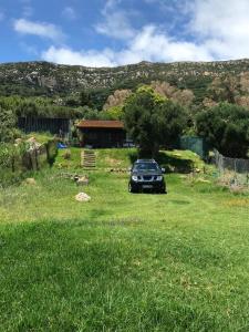 a car parked in a field in front of a house at Rustic Cabin Tarifa 4 guests 10 minutes to beach in Tarifa