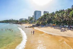a beach with a bunch of people in the water at Chez Eva Jolie in Dakar