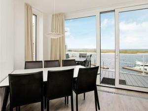 a dining room with a table and chairs and a large window at One-Bedroom Holiday home in Wendtorf 4 in Wendtorf
