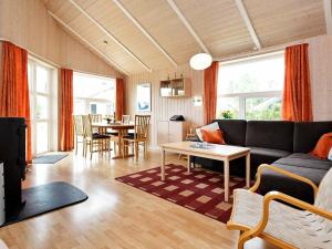 een woonkamer met een bank en een tafel bij 4 person holiday home in Otterndorf in Otterndorf